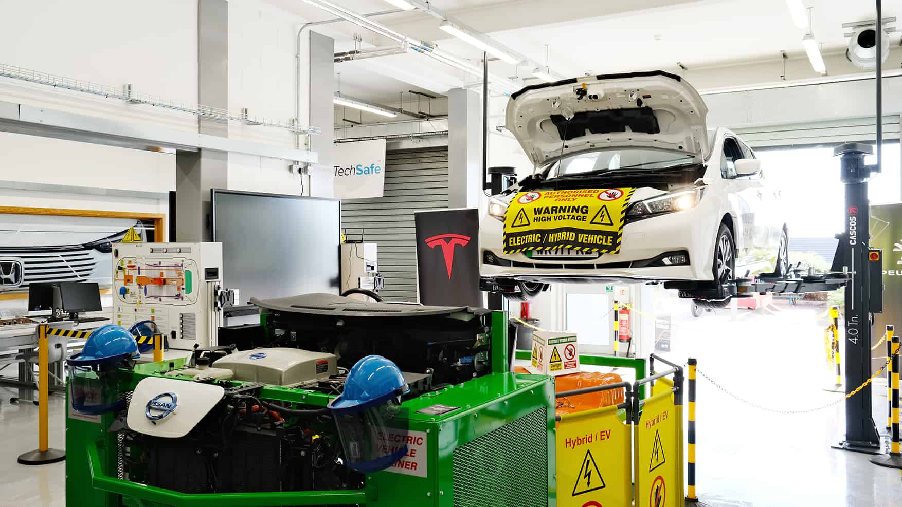 EV Labs 7 An electric car is being serviced in the automotive bay.