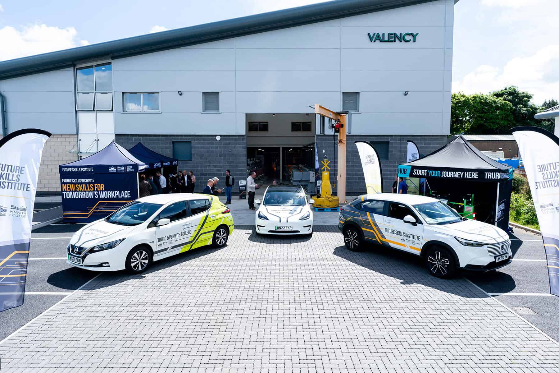 Three of the College's electric vehicles outside of the Valency building at Truro College