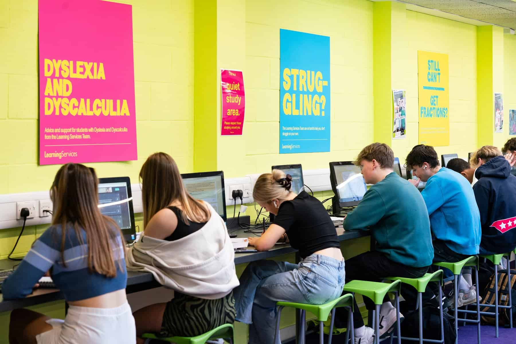Student Support 0010 Students work at desks in front of computers in the quiet study area.