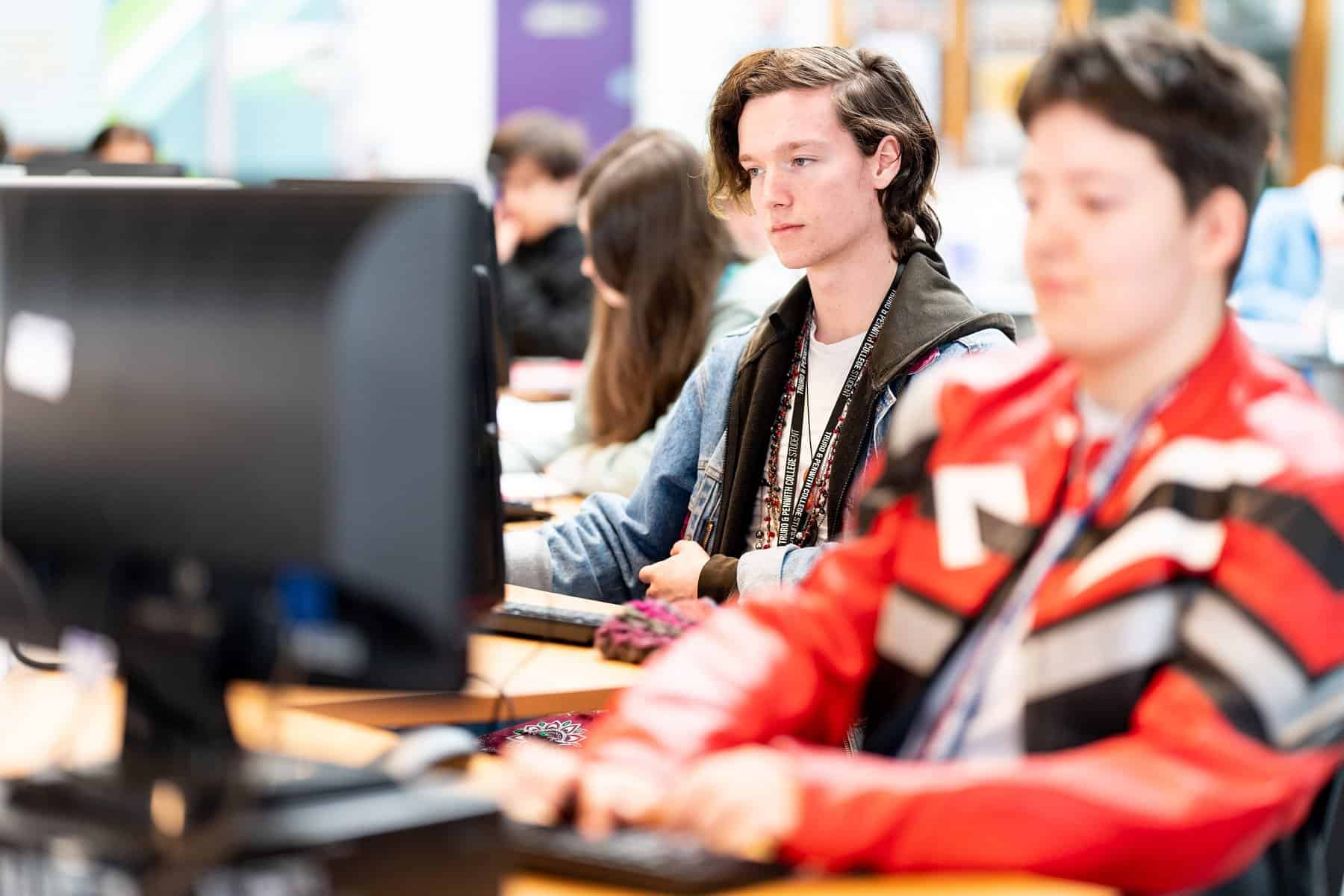 General FE TC 064 Students sitting the the Learning Centre at individual desks with computers.