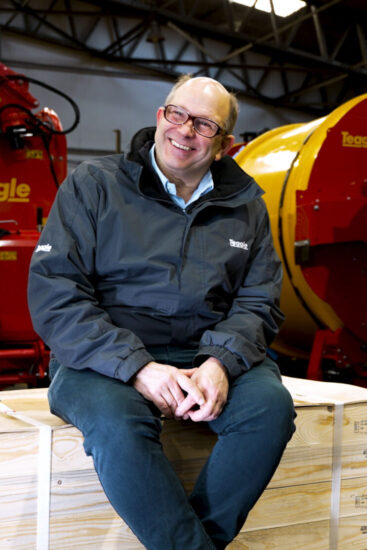 Teagle Cropped Duncan Wilson sitting on a pallet in the Teagle workshop.